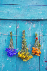 three medical herbs flower bunch on wooden door