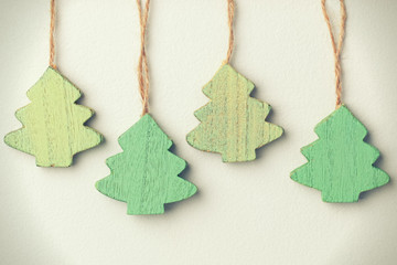 Green vintage wooden christmas trees hanging on a string
