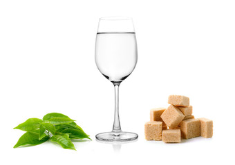 Glass of water and tea leaves ilsolated on white background