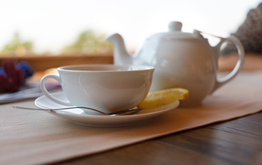 Obraz na płótnie Canvas Tea with lemon and tea maker