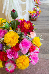 Artificial fake flowers placed on the steps of a beautiful