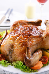 Delicious baked chicken on plate on table on light background