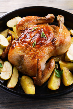Delicious baked chicken on table close-up