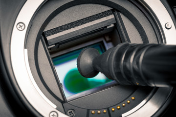 Image photo sensor being cleaned with a lens pen.