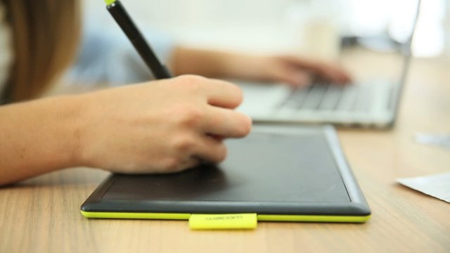 Closeup of hand working on graphic tablet