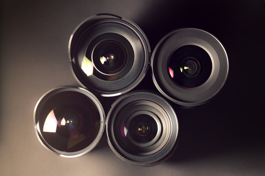 Set Of DSLR Lenses, Different Sizes And Reflections. Cross