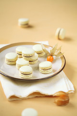 Fototapeta na wymiar Light Yellow Macarons with Chocolate and Passionfruit Ganache