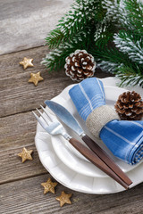 Christmas table setting with spruce branches on wood