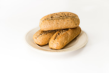Three baguettes on an off-white plate
