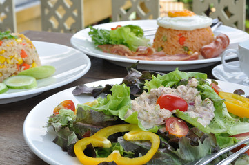 Meal set and tuna salad on wooden table