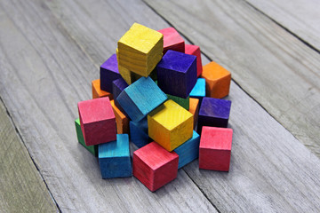 colorful wooden cubes on wood background