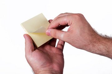 Hands holding up yellow notes