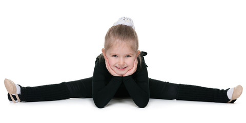 Pretty little girl performs gymnastic exercise