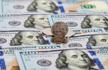 Russian rubles coins and dollars banknotes close up
