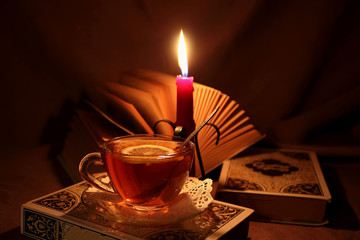 Open book and a cup of hot tea.