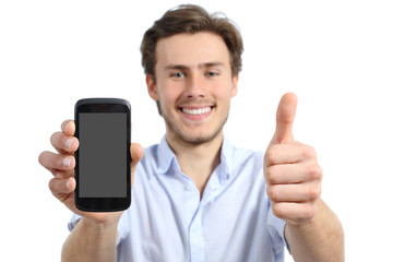 Young man showing a blank smart phone screen with thumbs up