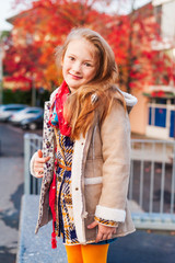 Autumn portrait of a cute little girl