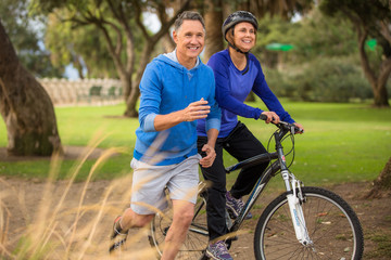 Elder couple exercising in the park - 73498966