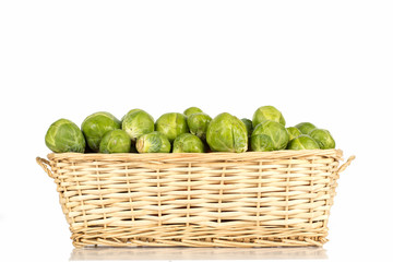 Basket full of brussel sprouts isolated on white