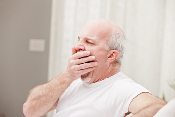 man yawning and going asleep