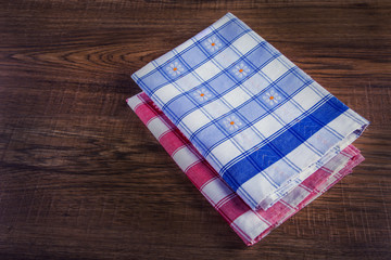 Top view of checkered napkin on empty wooden table