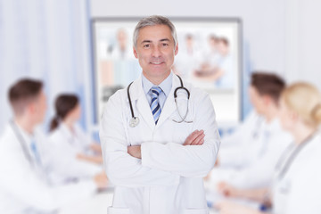 Doctor With Arms Crossed In Meeting Room