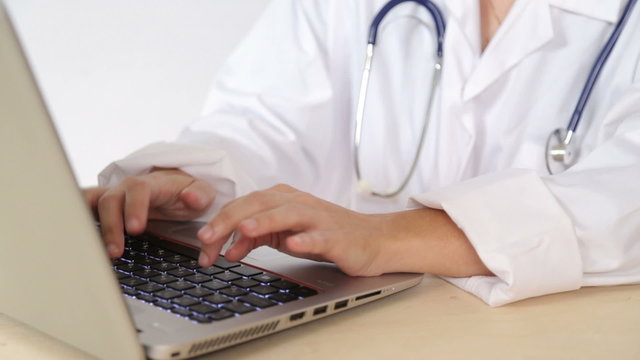 Doctor use laptop computer to perform medical research online