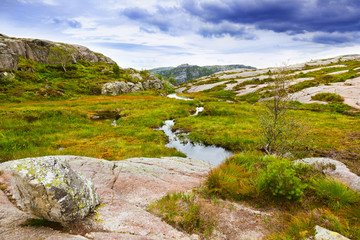 Mountains on the way to the Cliff Preikestolen in fjord Lysefjor