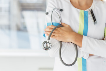 Close-up photo of female doctor holding stethoscope
