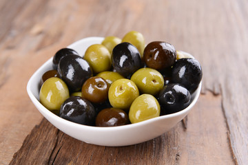 Different marinated olives on table close-up