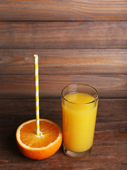 Glass of orange juice and fresh orange