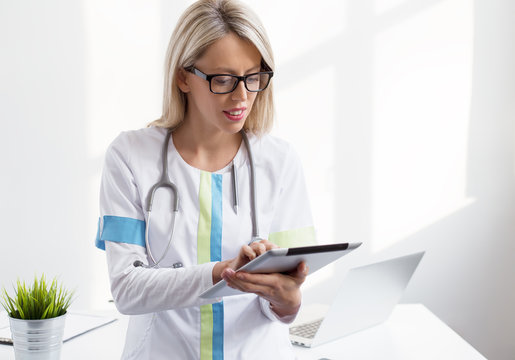 Young female doctor working with ipad