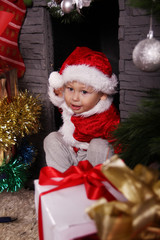 Fototapeta na wymiar baby Santa Claus with Christmas gifts