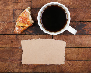 Composition of coffee, fresh croissant and paper card