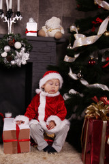 Fototapeta na wymiar Santa baby sleeping under the Christmas tree