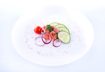 Appetizing fish salad with vegetables on plate isolated on