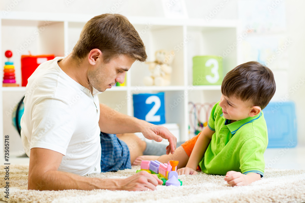 Wall mural father with his child son play together