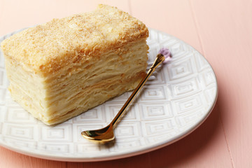 Napoleon cake on plate on table close-up