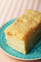 Napoleon cake on plate on table close-up