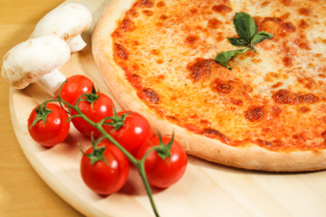 Delicious pizza on wooden plate