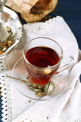 Beautiful vintage composition with herbal tea, on wooden table