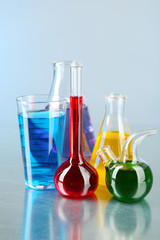 Different laboratory glassware with colorful liquid