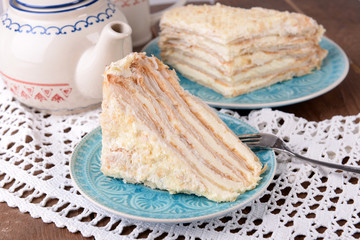 Napoleon cake with tea on table close-up