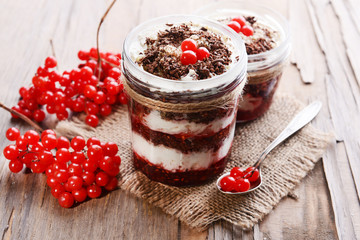Delicious dessert in jars on table close-up