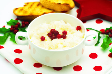Rice porrige in the white dish with cranberries