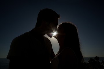 Cute couple kissing in silhouette