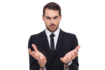 Cheerful businessman presenting with his hands