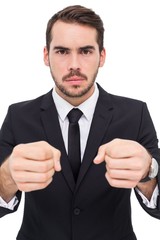 Frustrated businessman with closed fists looking at camera