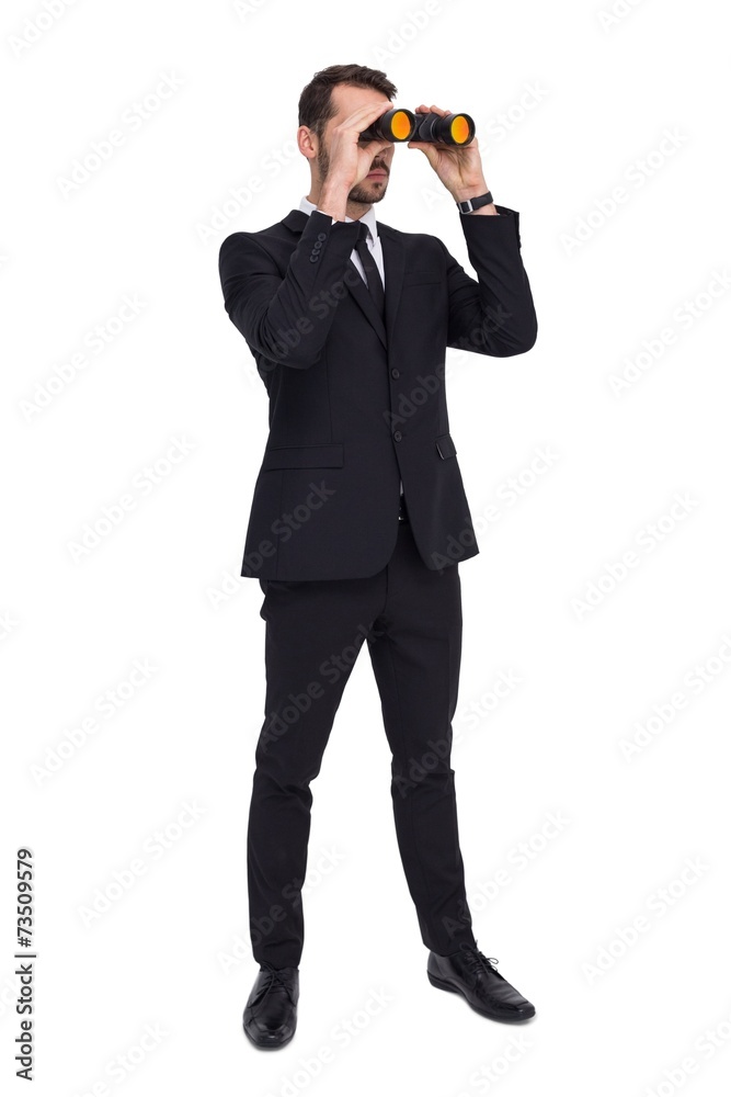 Poster elegant businessman standing and using binoculars