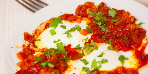 eggs poached in a sauce of tomatoes, chili peppers, and onions